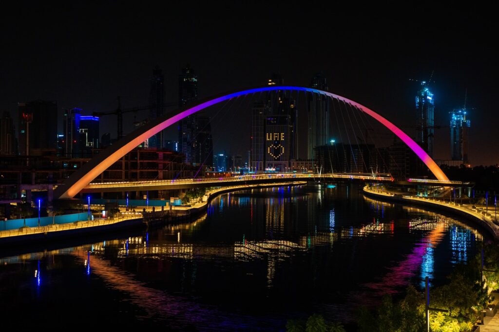 lighted bridge over body of water during nighttime