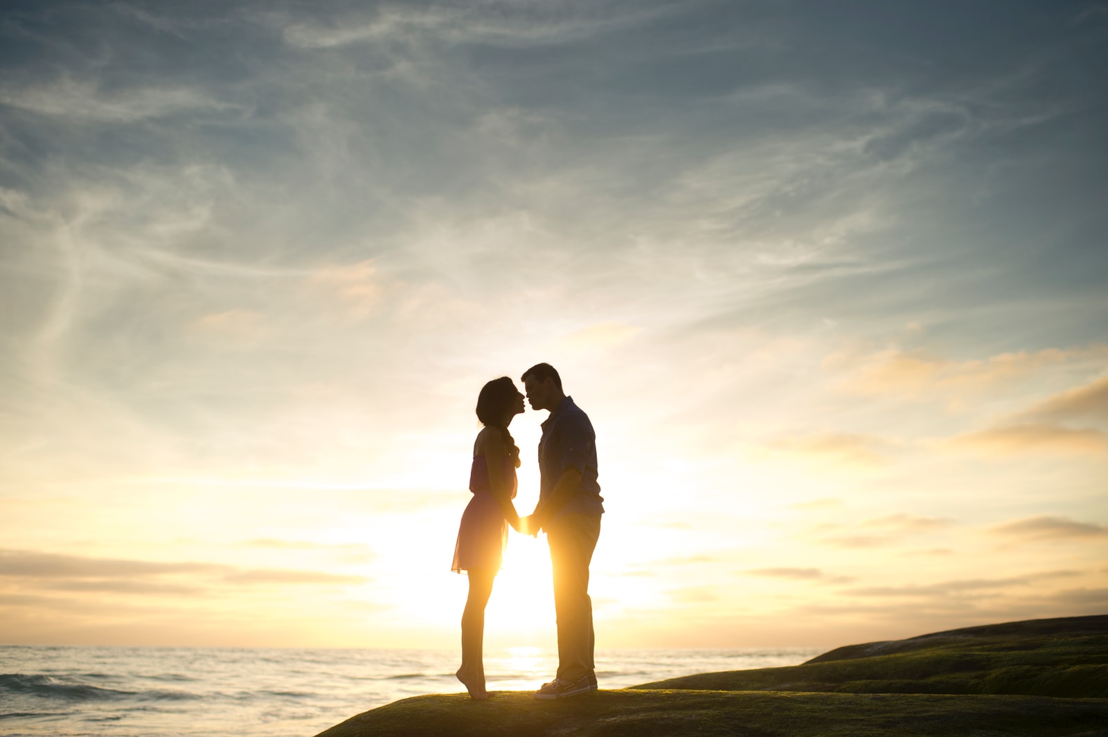 silhouette of man and woman about to kiss