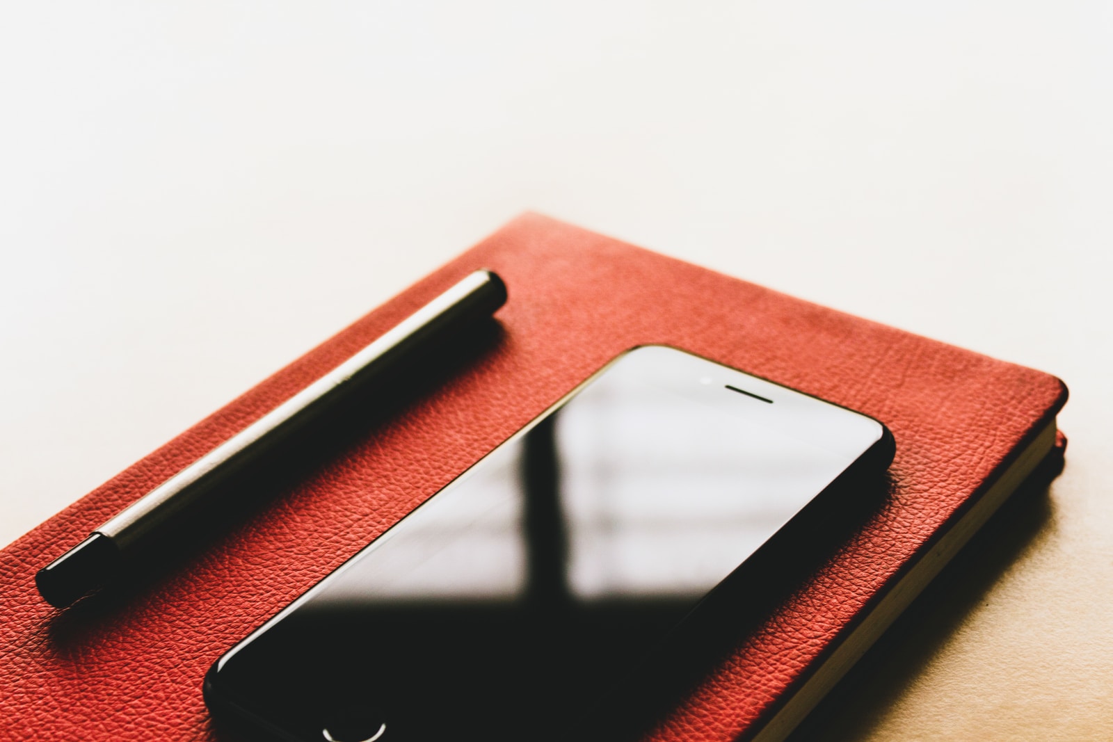black iPhone on red book