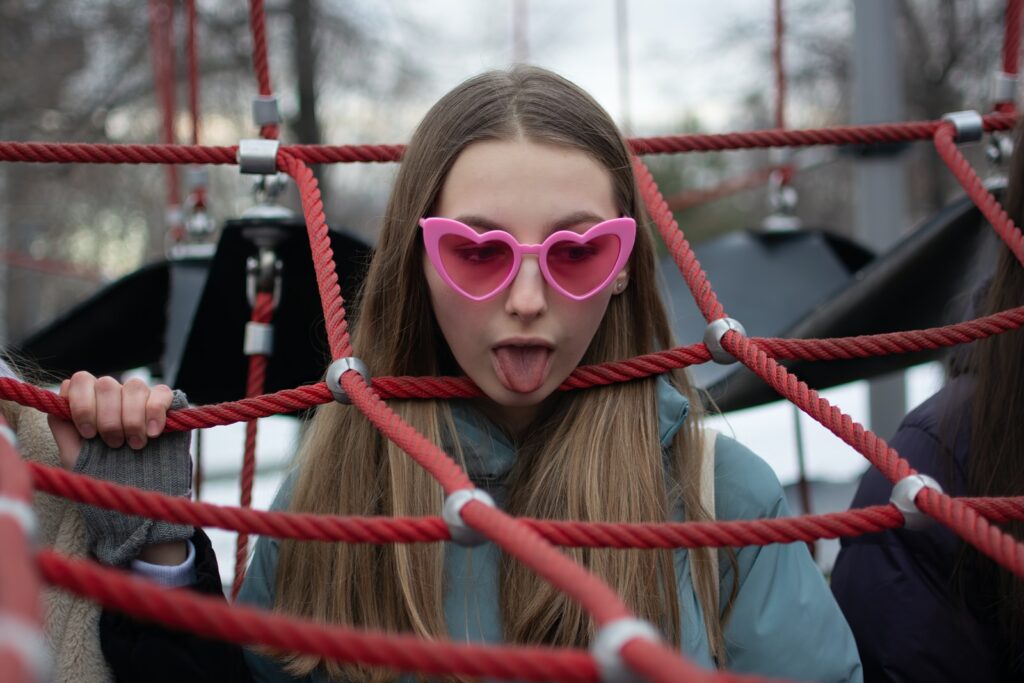 girl in white long sleeve shirt wearing brown sunglasses