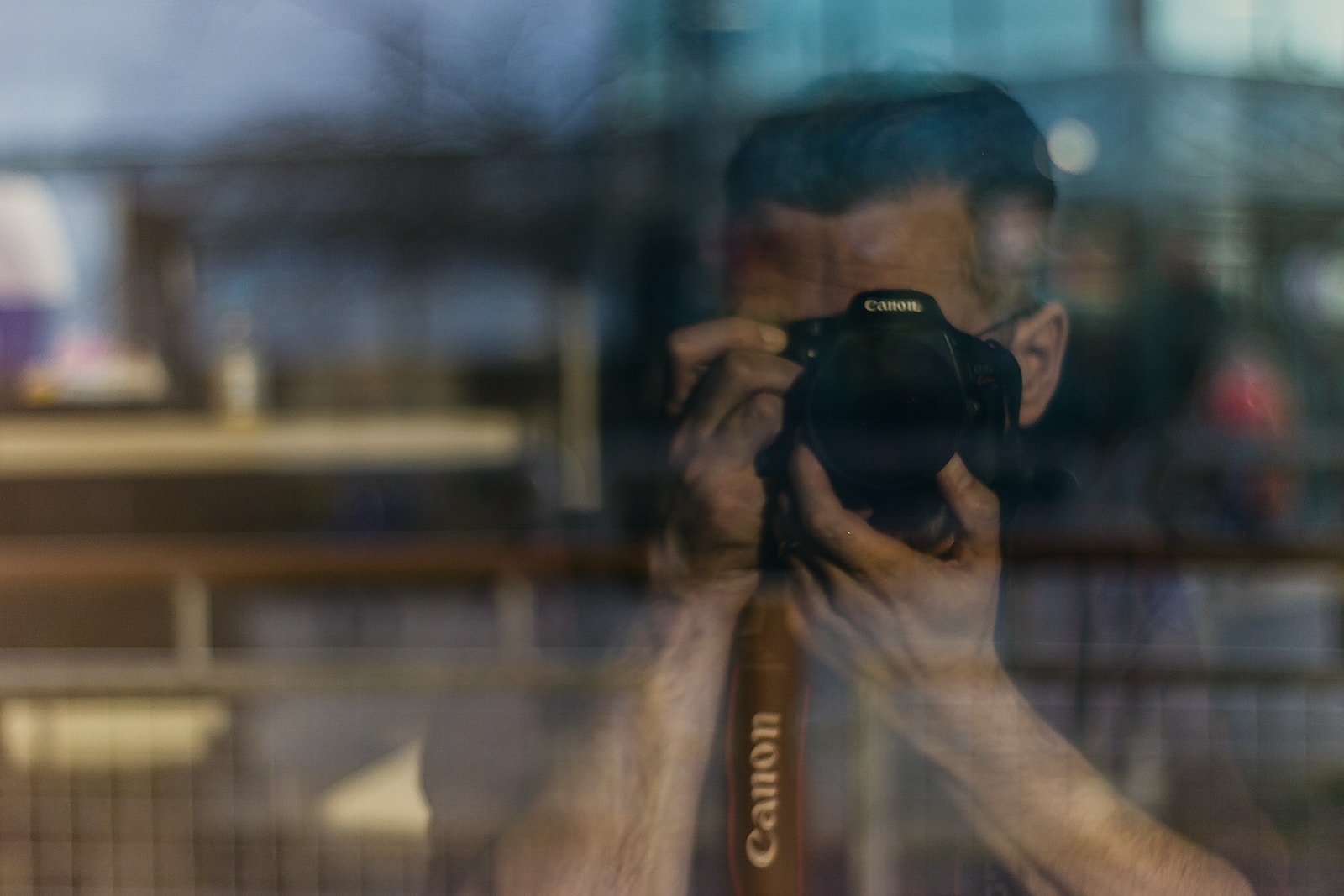 man holding DSLR camera