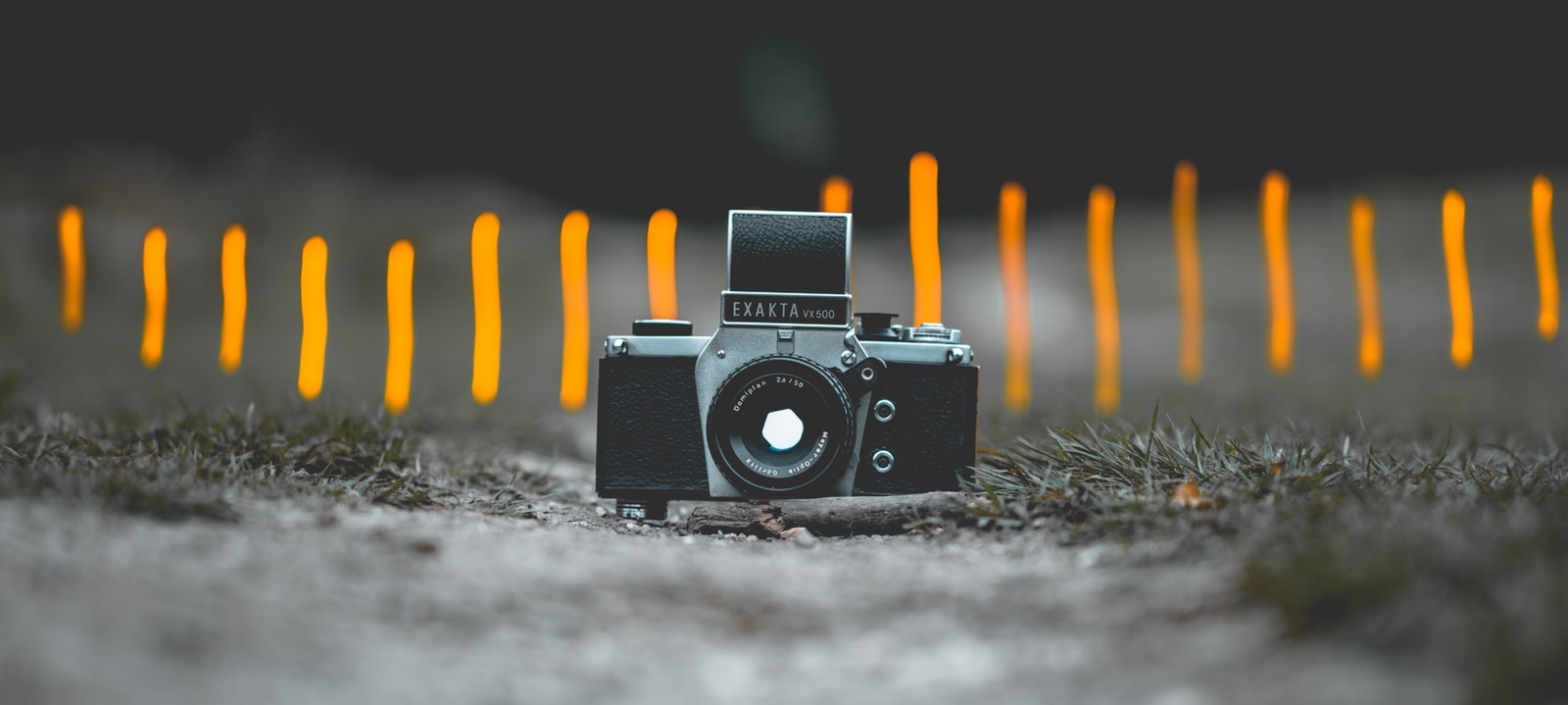 selective focus photography of black and gray SLR camera on gorund