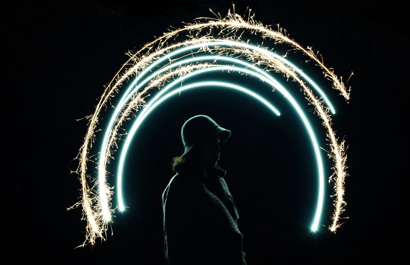 Time lapse Photo Of Semi-Circle Light Painting With A Woman In The Center