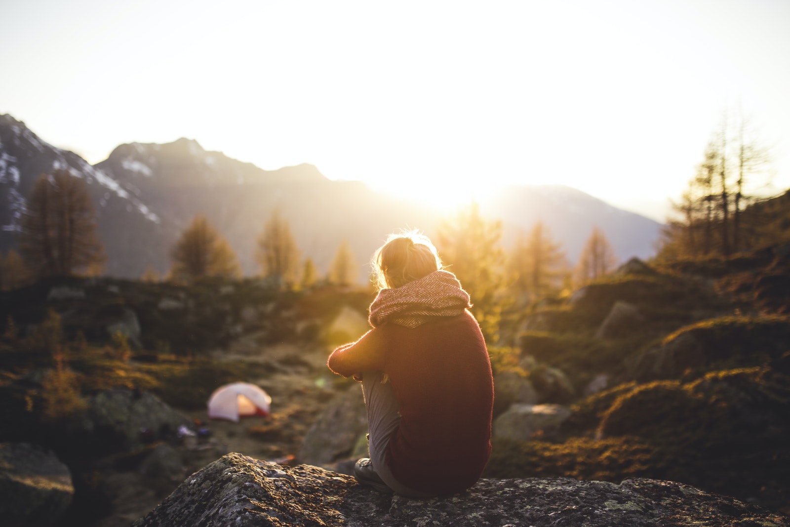 Person Sitting on Rock at Golden Hour