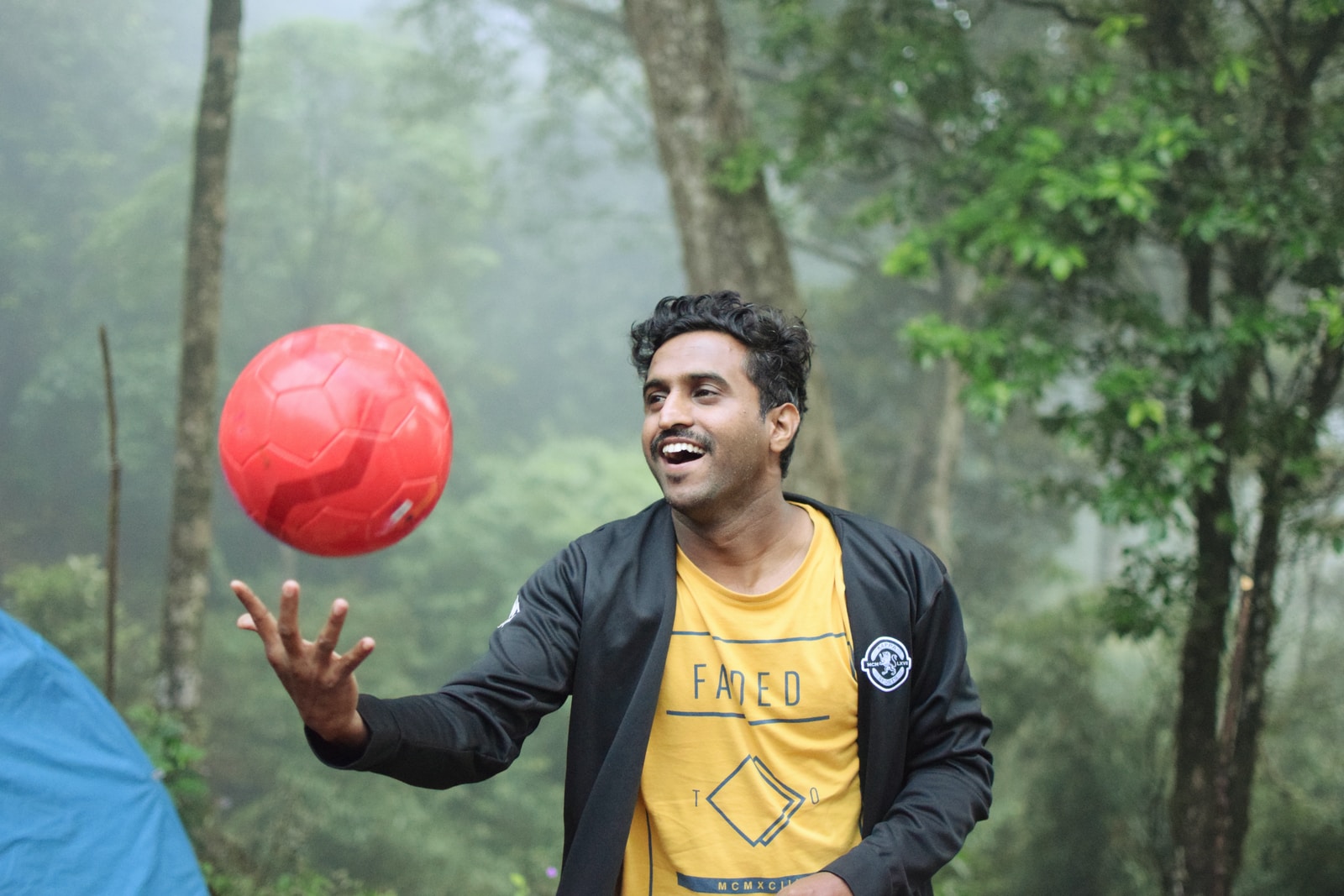man playing red soccer ball