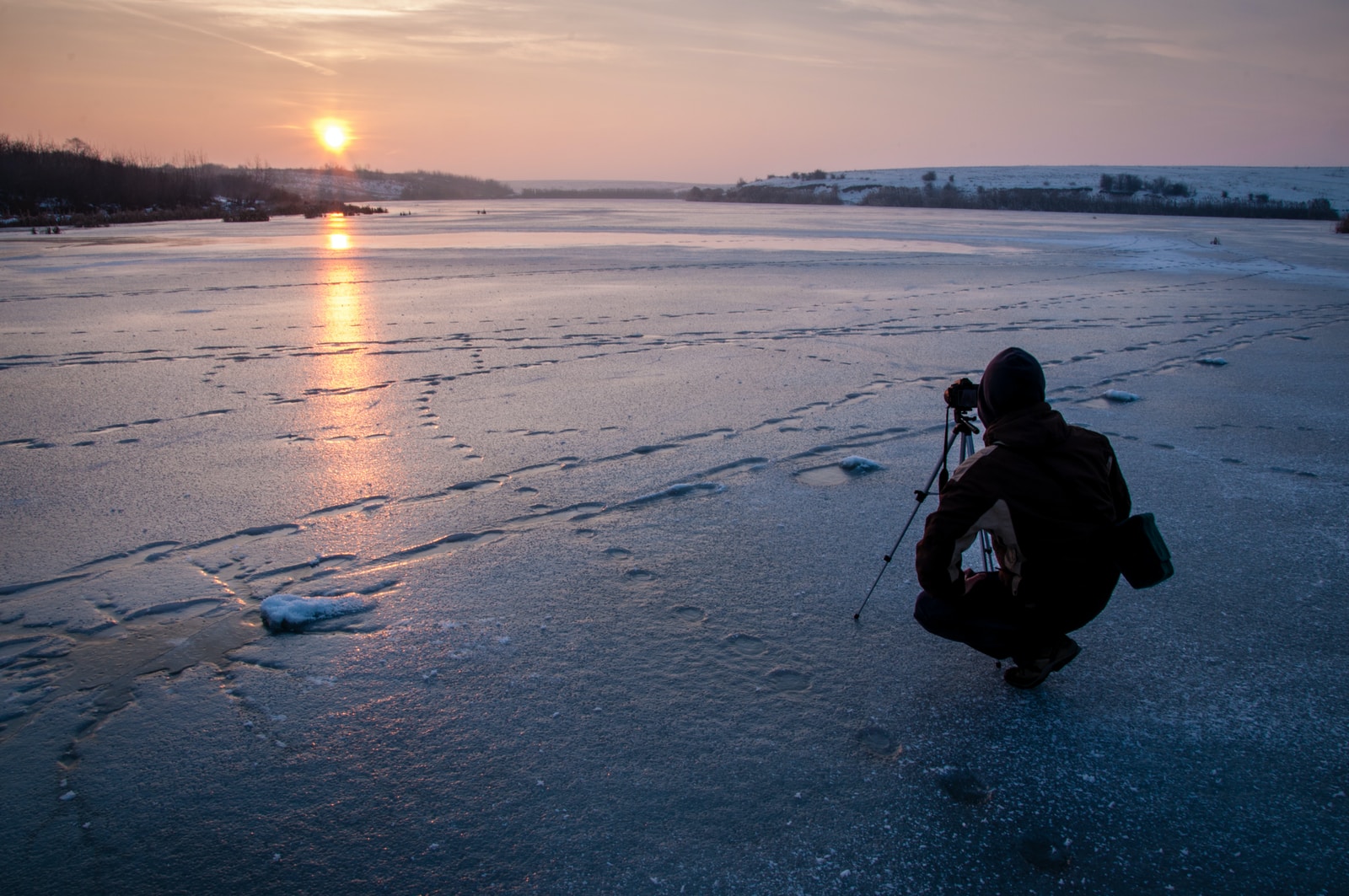 man taking photo of sunset