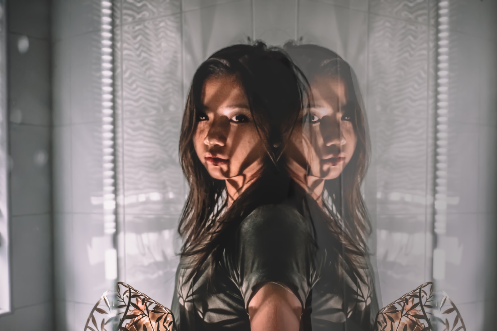 woman in black shirt leaning on glass