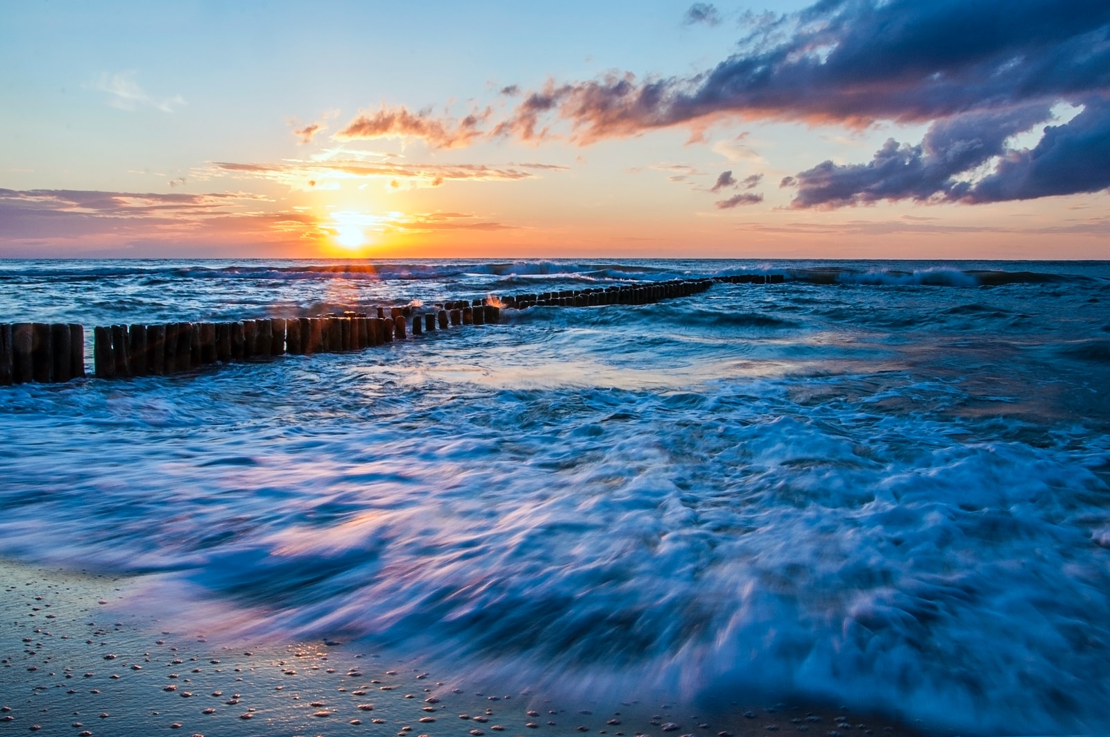 brown wooden docks on blue boy of water at daytime