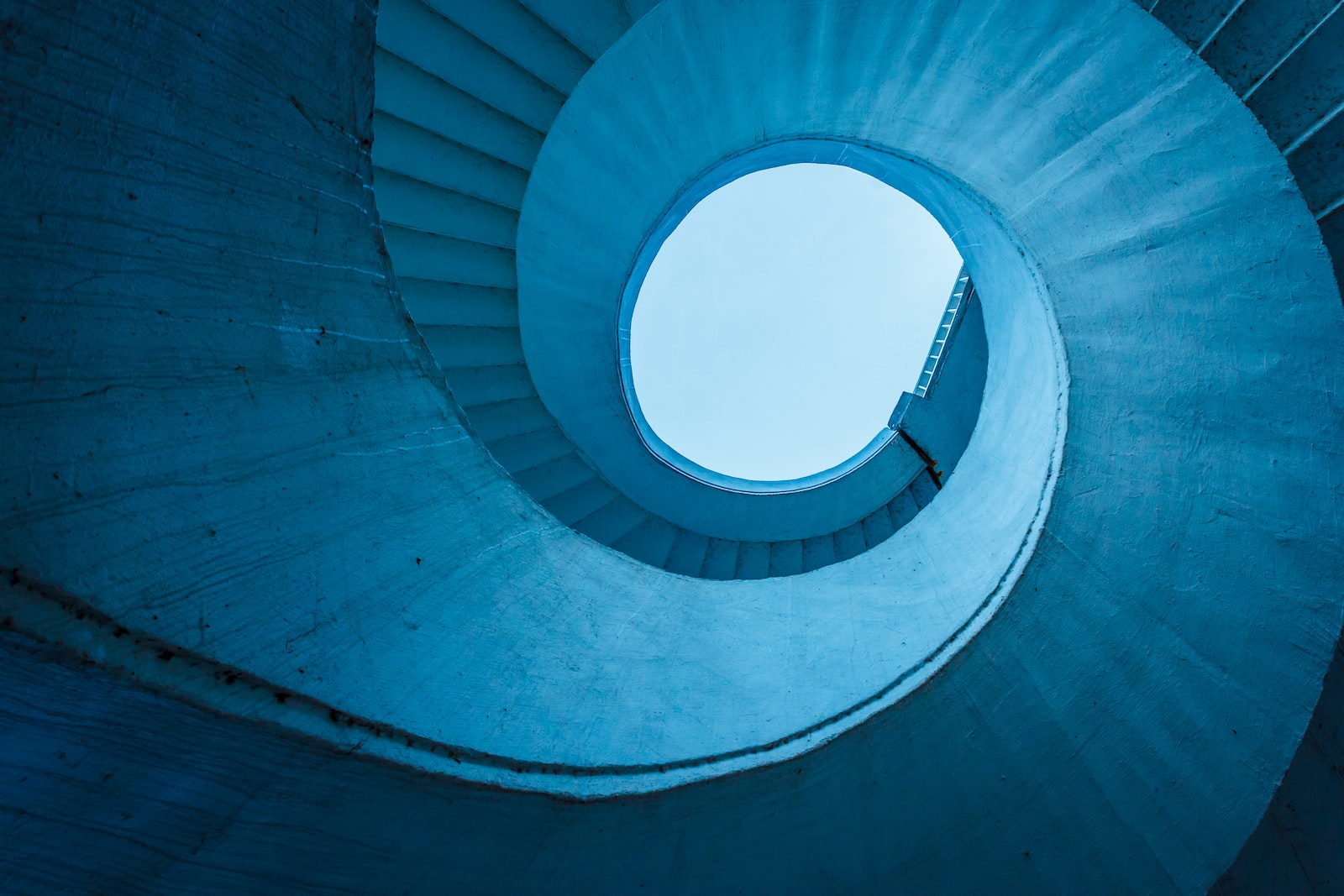 architectural structure photography of spiral stairs