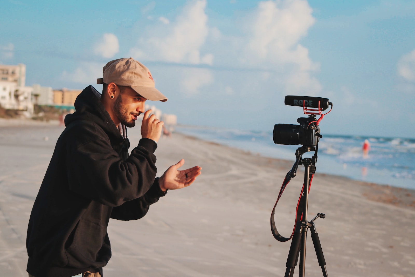 man in black jacket holding camera during daytime